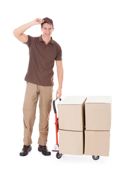 Delivery Man Standing Near Boxes And Hand truck — Stock Photo, Image