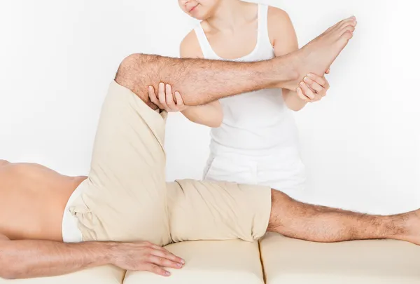 Mujer Masajeando el pie del hombre —  Fotos de Stock