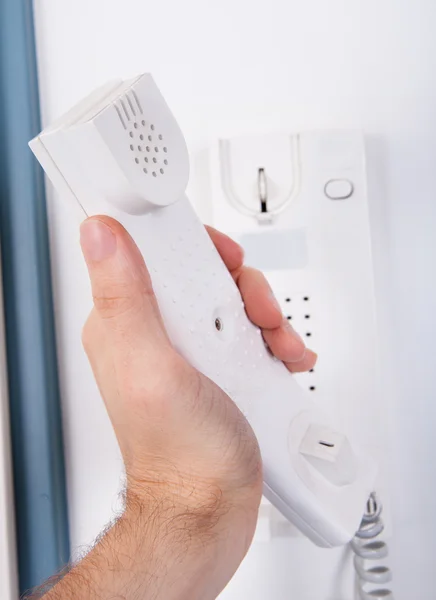 Hand Over Telephone On Wall — Stock Photo, Image