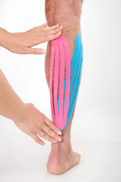 Person Applying Physio Tape On Calf — Stock Image Person Applying Physio Tape On Calf Stock Photo
