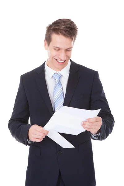 Young Businessman Reading Document Over White Background — Stock Photo, Image