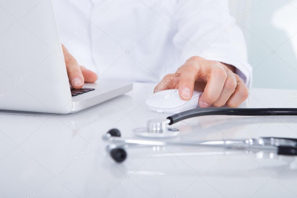 Close-up Of Doctor Using Laptop