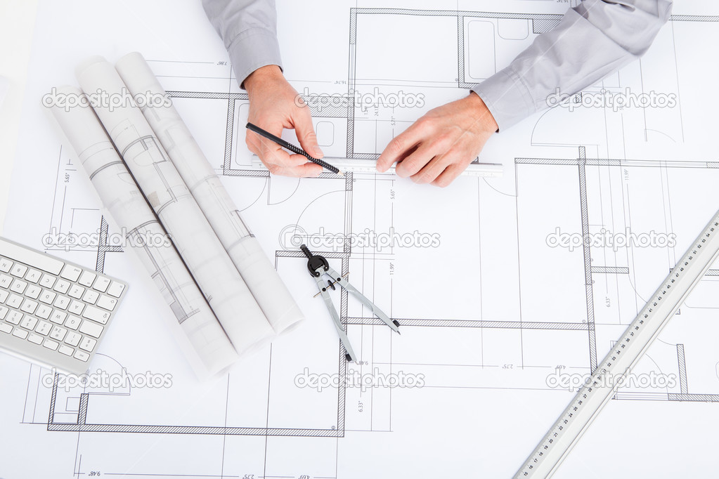 Architect Drawing On Blueprint