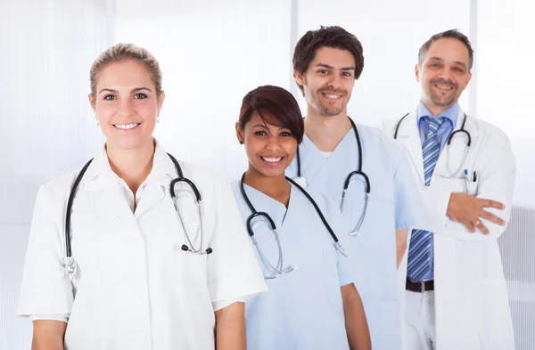 Group of doctors standing together over white — Stock Photo, Image