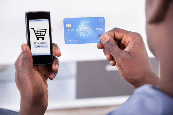 Person Holding Credit Card And Mobile Phone — Stock Photo, Image