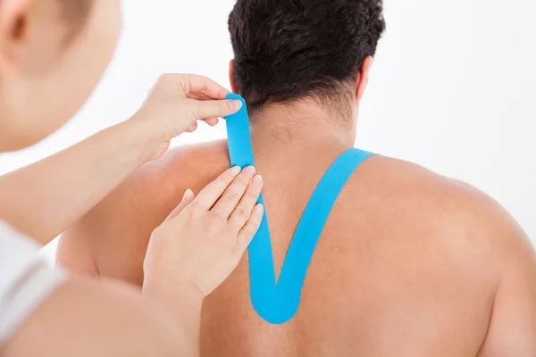 Applying Special Physio Tape On Man's Back — Stock Photo, Image