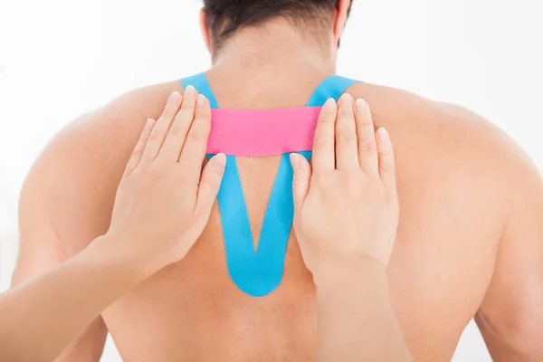 Vrouw physio tape op mens toe te passen — Stockfoto