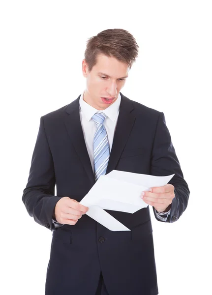 Joven Empresario leyendo documento sobre fondo blanco —  Fotos de Stock