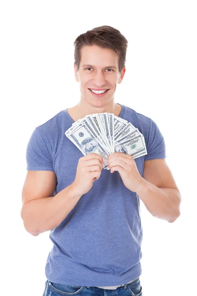 Retrato de un joven feliz sosteniendo dólares americanos — Foto de Stock