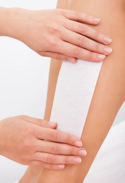 Kosmetolog vaxning en kvinnas ben — Stockfoto