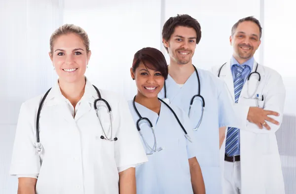 Group of doctors standing together over white Stock Picture