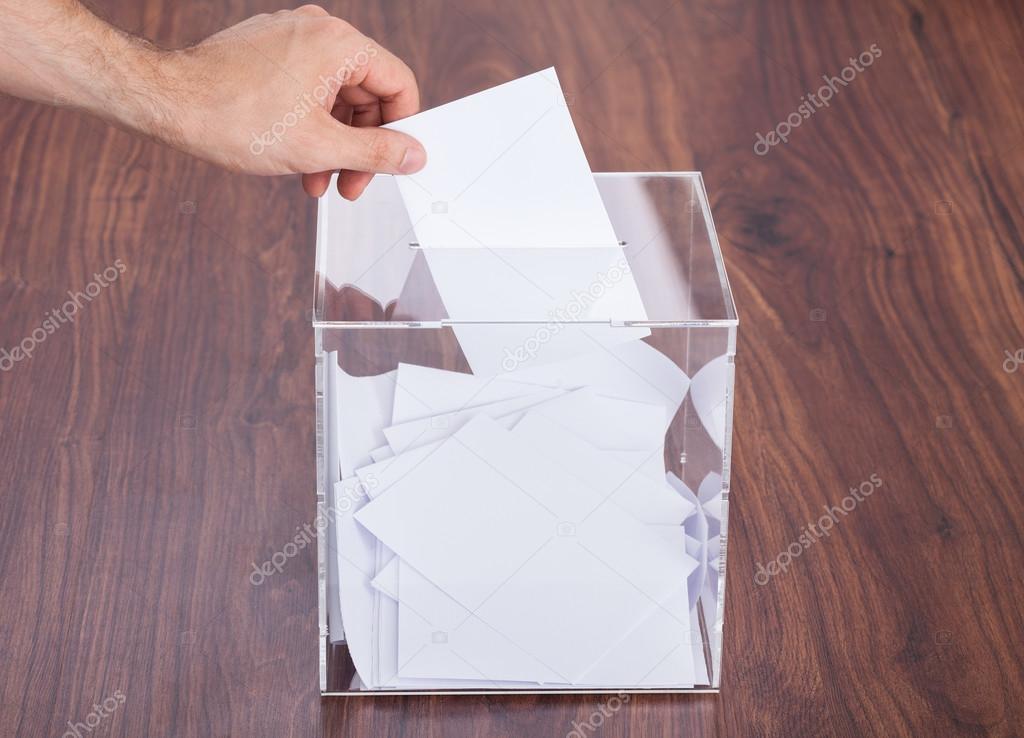 Person Putting Ballot In Box
