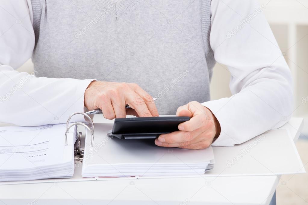 Happy Mature Man Holding Calculator And Bills