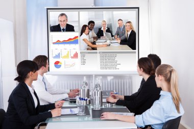 Businesspeople In Video Conference At Business Meeting clipart