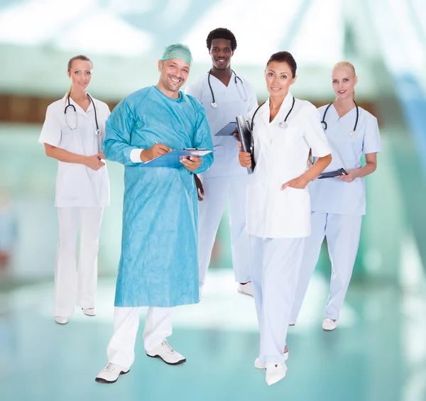 Happy Doctor In Surgical Gown With His Coworkers — Stock Photo, Image