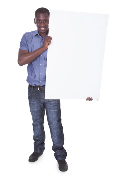 Homem africano com placa branca — Fotografia de Stock