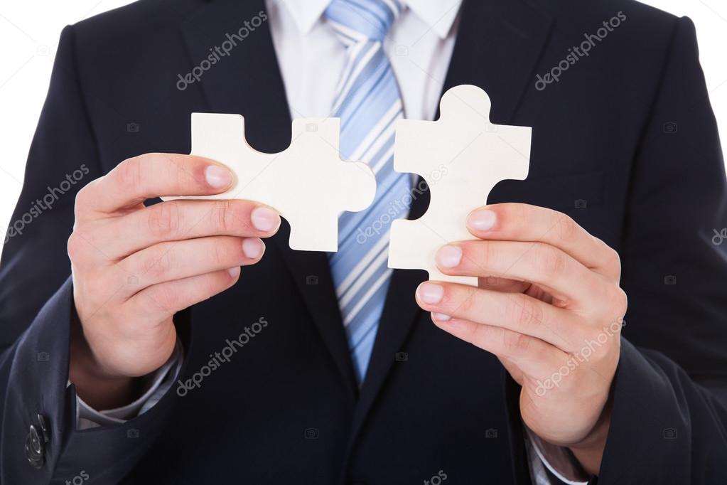 Businessman Solving Jigsaw Puzzle