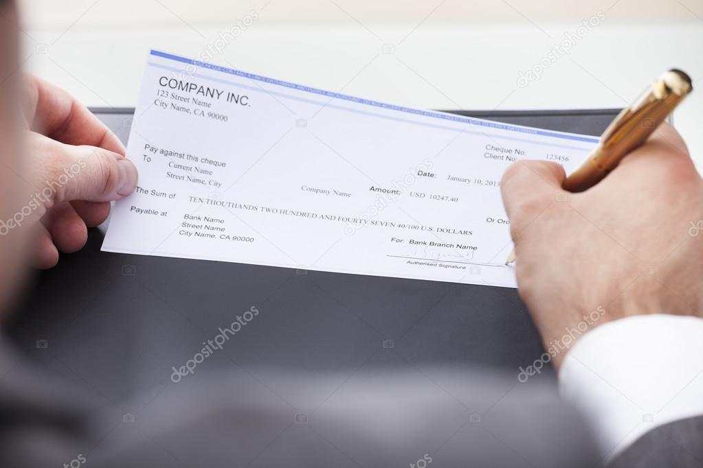 Businessman Filling Blank Cheque