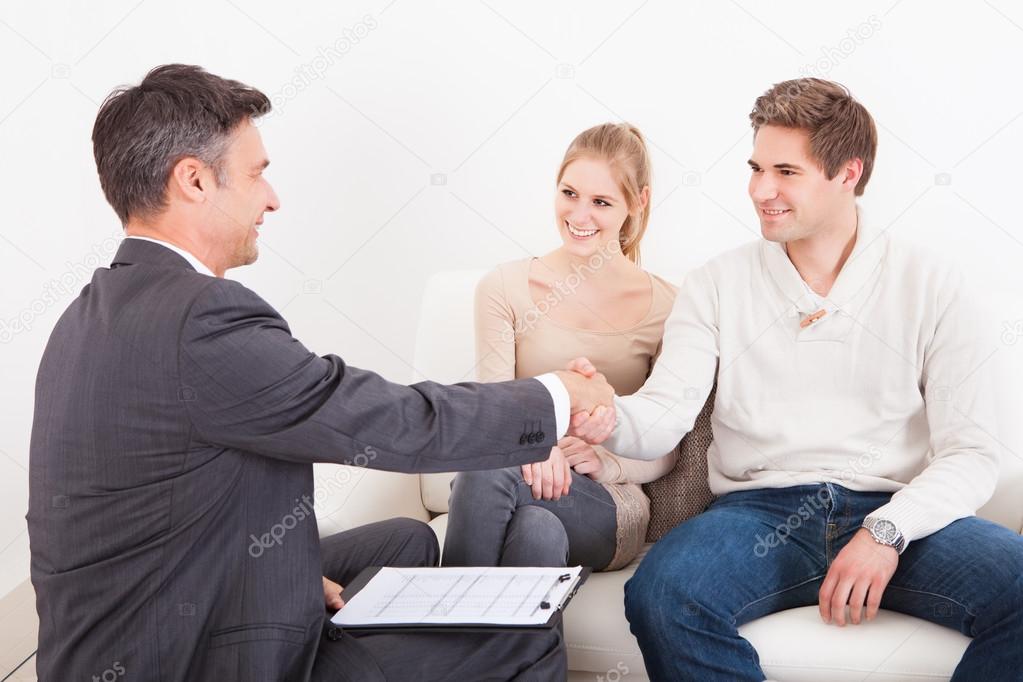 Consultant Shaking Hand With Customer