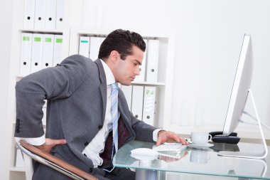 Businessman Suffering From Back Pain clipart