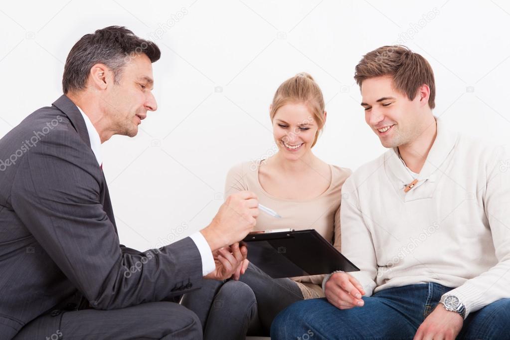 Consultant Showing Clipboard To Couple