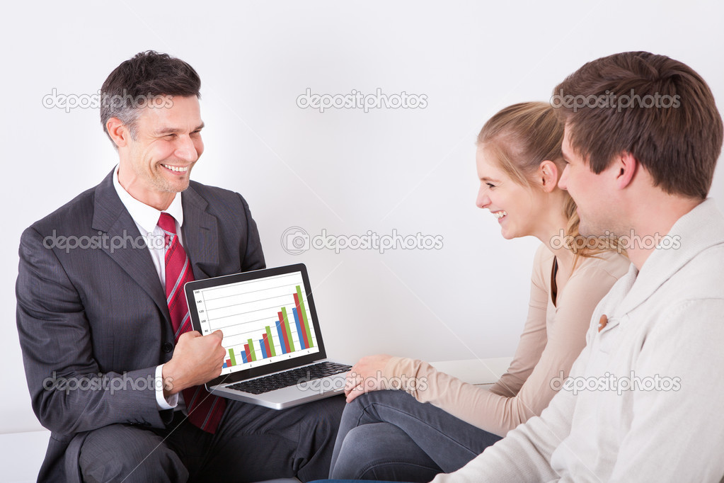 Advisor Showing Graph On Laptop To Couple
