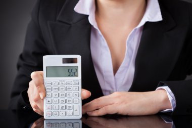 Businessperson Hand On Calculator