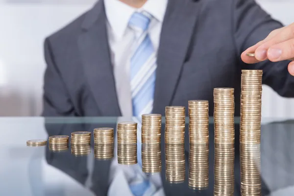 Businessperson With Stack Of Coins — Stock Photo, Image