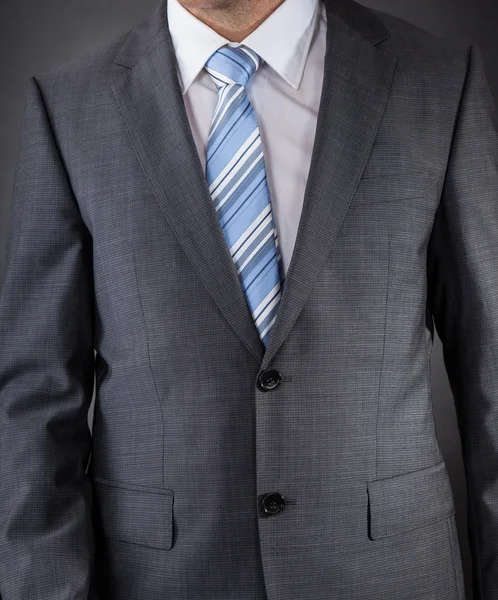 Muž, oblečený v obleku s pruhovanou kravatu — Stock fotografie