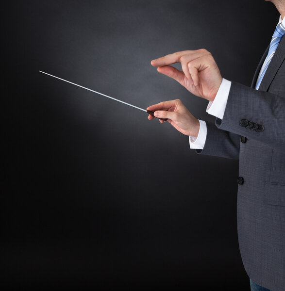 Orchestra Conductor Holding Baton