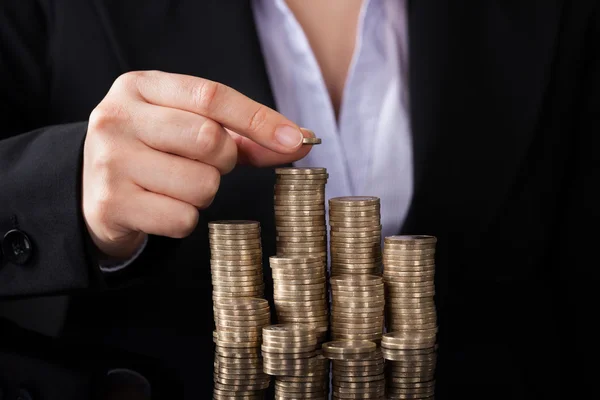 Mujer de negocios con fila de monedas — Foto de Stock