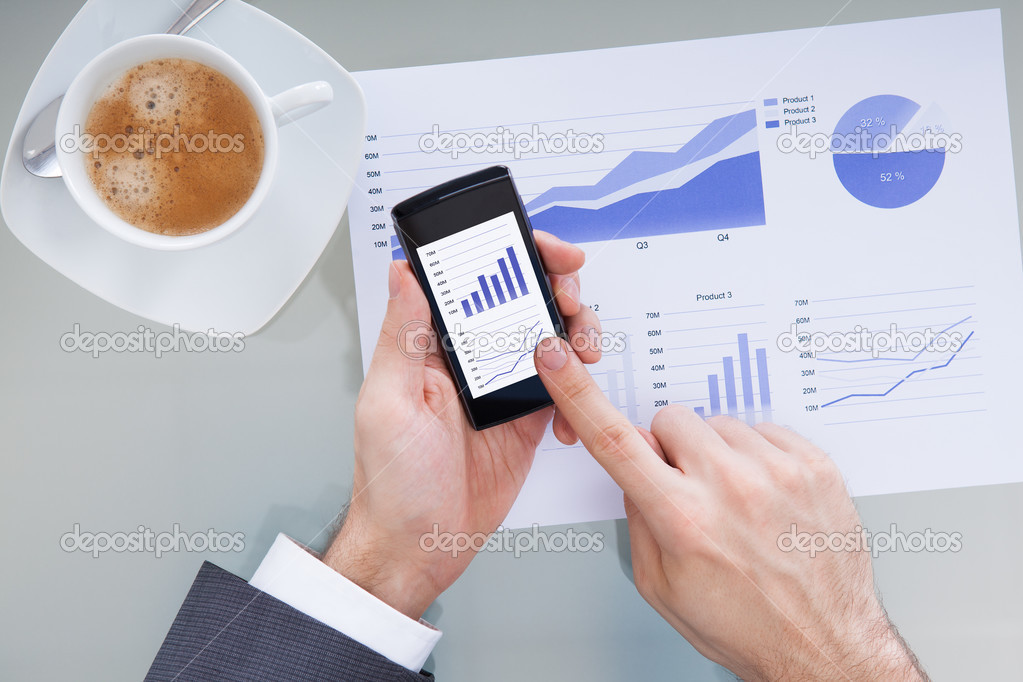 Businessperson With Mobile Phone Showing Graph