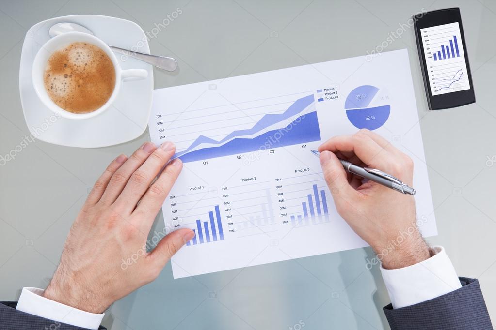 Businessperson Hand With Pen Over Graph Diagram