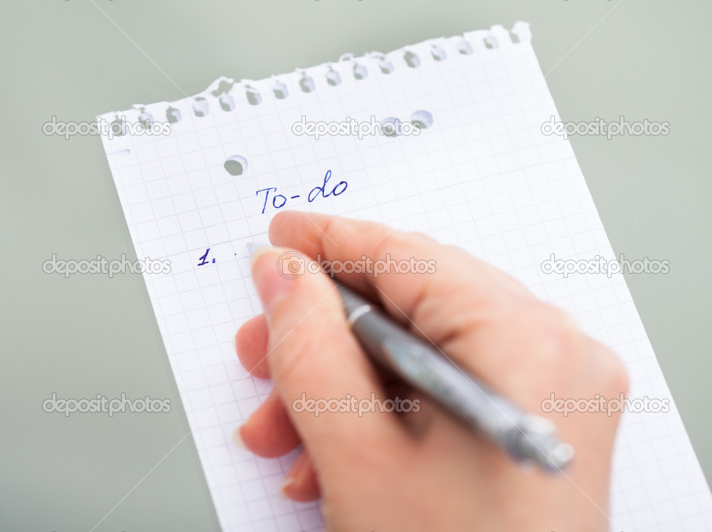 Hand With Pen Filling Out To Do List