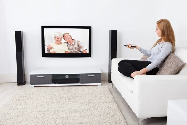 Mulher assistindo filme na televisão — Fotografia de Stock