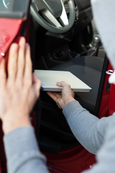 Ladrón robar el ordenador portátil a través de la ventana del coche — Foto de Stock