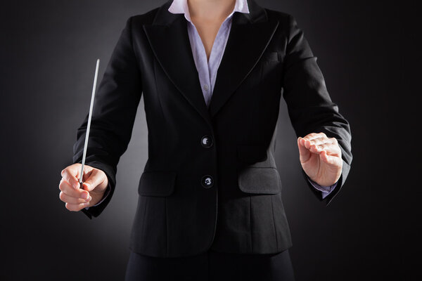 Female Orchestra Conductor With Baton
