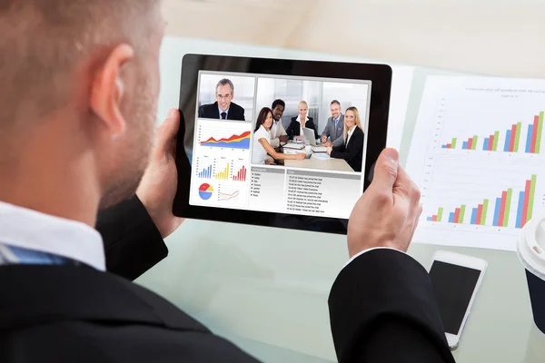 Businessman on a video or conference call on his tablet — Stock Photo, Image