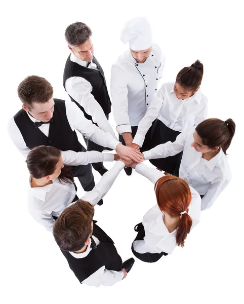 Waiters and waitresses stacking hands — Stock Photo, Image