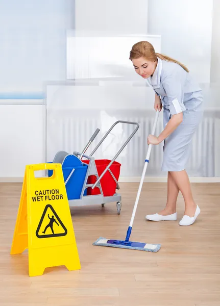 Happy Maid Cleaning Floor with Mop — стоковое фото