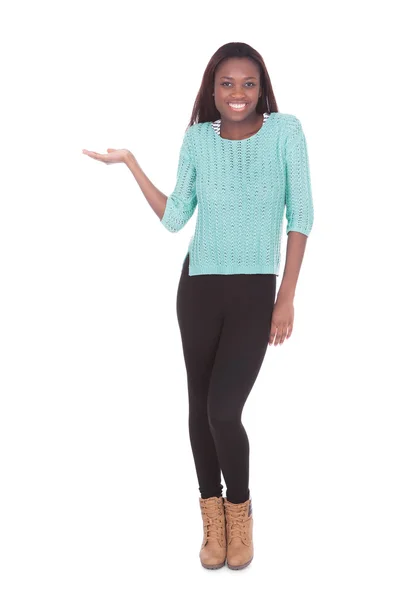 Woman holding invisible product against white background — Stock Photo, Image