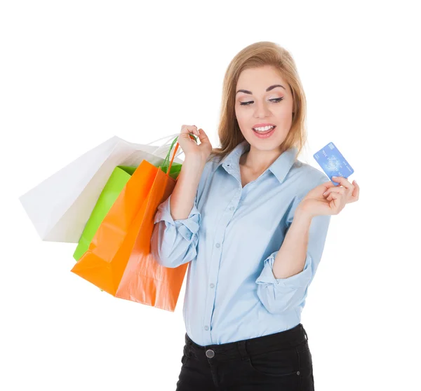 Woman With Shopping Bags Holding Credit Card Royalty Free Stock Photos