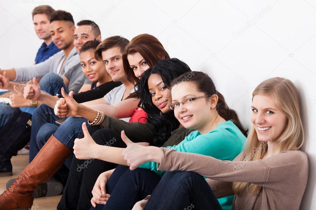 Confident University Students Sitting In A Row