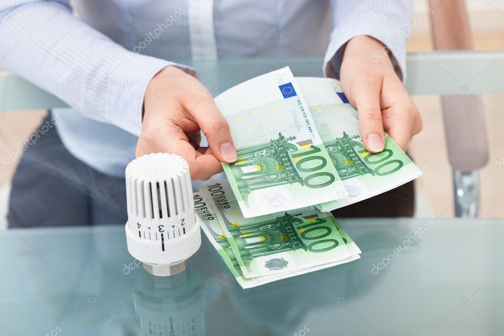 Businessperson With Valve Counting Money