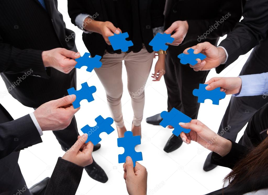 Business people connecting puzzle pieces