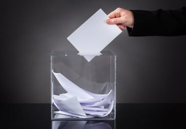 Hand Putting Ballot In Box clipart