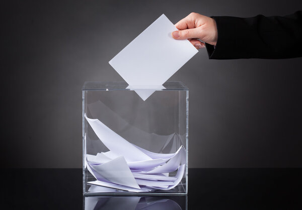 Hand Putting Ballot In Box