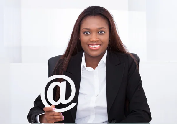 Femme d'affaires confiante tenant des pièces de puzzle dans le bureau — Photo