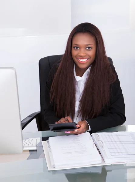 Selbstbewusste Geschäftsfrau berechnet Steuer am Schreibtisch — Stockfoto