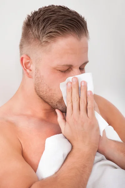 Man with a cold blowing his nose — Stock Photo, Image